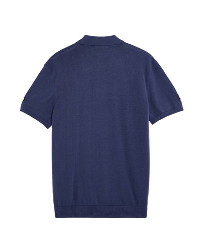 Back of a crown blue cotton knit polo shirt with short sleeves, a classic collar, and ribbed hem.
