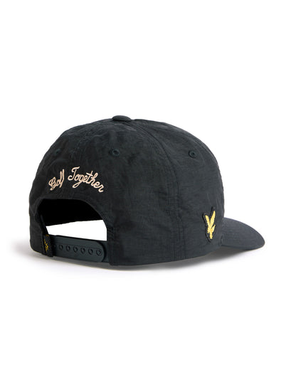 Back of a black nylon snapback featuring a yellow cursive Golf Together design and a side logo.
