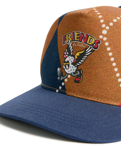 Detail of an argyle snapback with a navy brim and a printed winged golf ball graphic on the front.