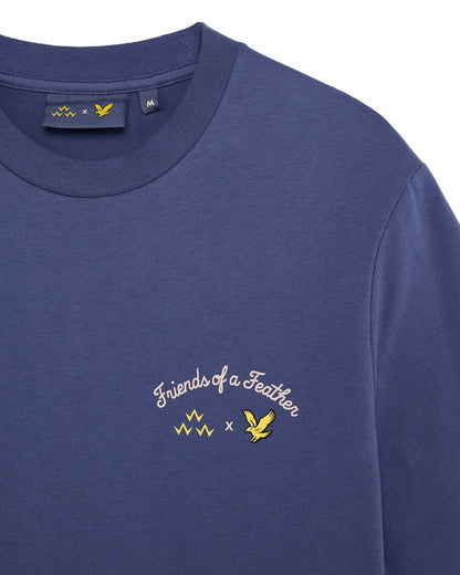 Detail of a crown blue t-shirt with a white arched text graphic and yellow bird logos on the chest.