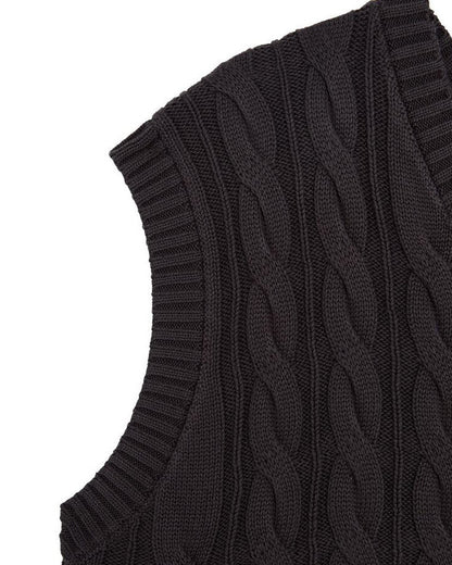 Detail of a black cotton cable knit vest featuring a ribbed V-neckline and armholes.