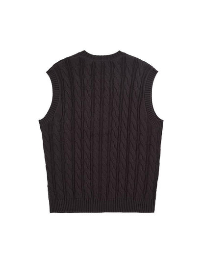 Back of a black cable knit vest with ribbed crewneck, armholes, and hem.
