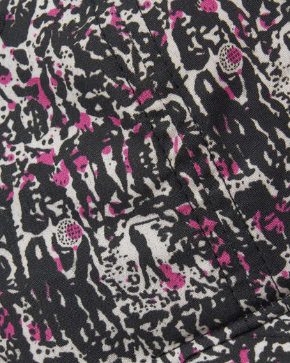 Detail of a black, white and pink cap featuring an all-over custom golf yardage graphic.