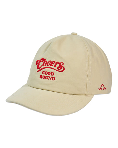 Cream five-panel cap with a soft peak, featuring a red Cheers Good Round logo and a small red logo on the side.