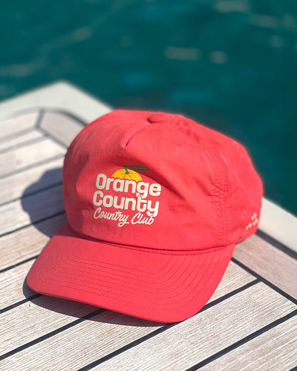 Blood orange 5-panel nylon cap featuring a front graphic depicting an orange and text.