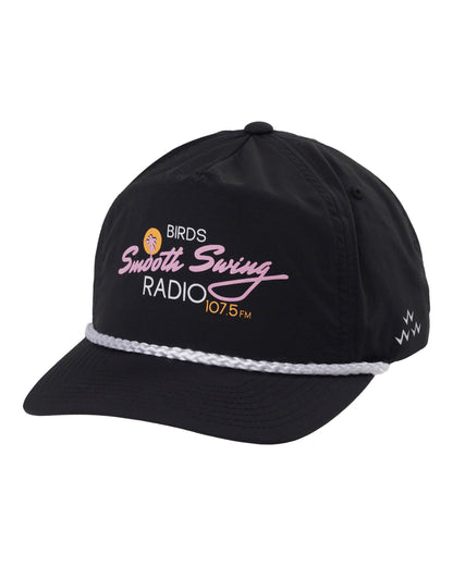 Black 5-panel snapback cap featuring a white rope across the brim and a pink and yellow radio graphic.