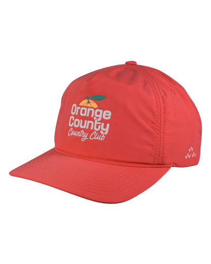 A red snapback cap with the 'Orange County Country Club' logo printed on the front.