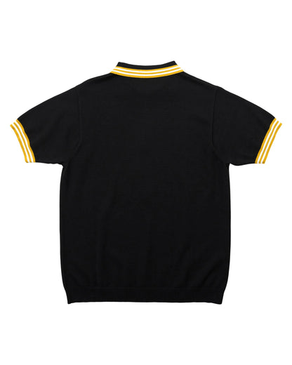 Back of a black cotton knit polo shirt featuring yellow and white striped ribbed collar and sleeve cuffs.