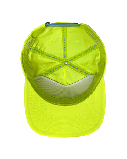 Inside of a lime nylon cap, showing taped seams with brand text and a blue strap closure.