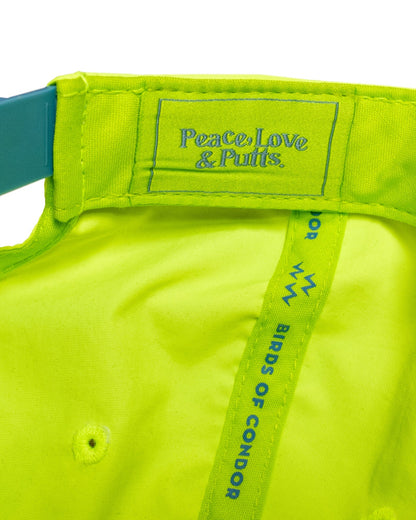 Detail of the interior lining of a lime snapback hat featuring a blue text design.