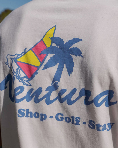 Back of a white t-shirt with a blue palm tree, sailboat motif, and Ventura Shop - Golf - Stay text.