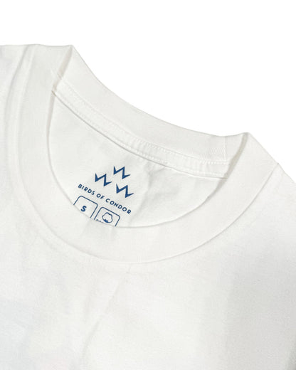 Detail of the crew neck and inner label on a white cotton t-shirt with blue branding.