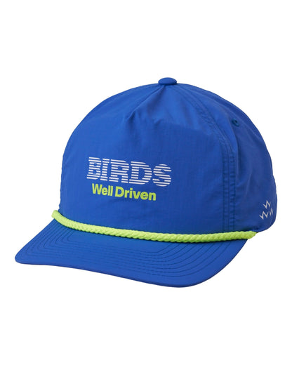 Blue five-panel snapback cap with a fluoro green rope across the brim and a printed graphic on the front.
