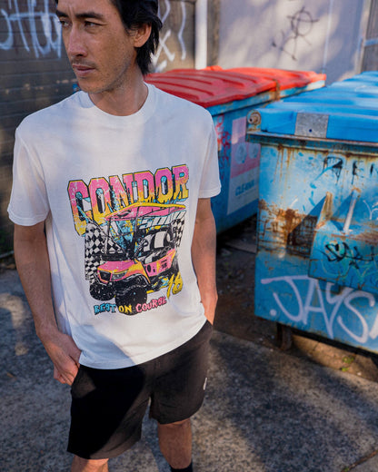 A man wearing a white t-shirt featuring a colourful retro graphic of a golf cart with text.