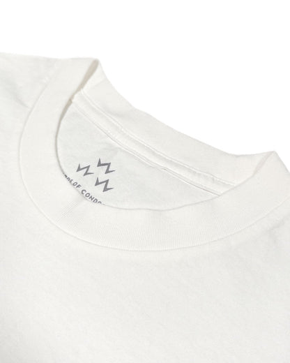 Detail of a white t-shirt collar featuring a zig-zag graphic and text printed inside the neckline.