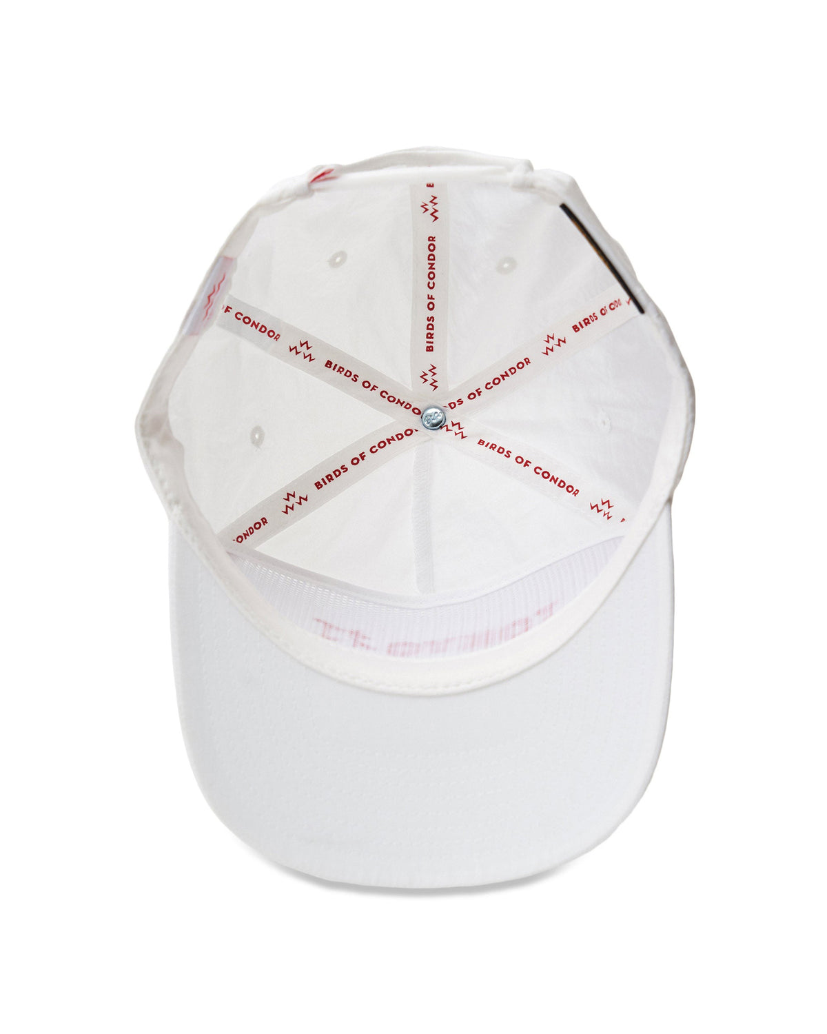 Interior view of a white snapback hat showing branded seam tape and text printed along the inner sweatband.