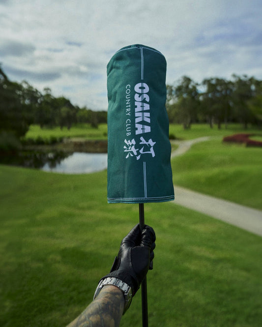 Alpine green headcover featuring white Osaka Country Club branding and white vertical accent lines.
