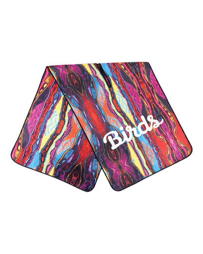 Flat-lay of a multi-coloured Coogi print microfiber golf towel featuring a white script logo.